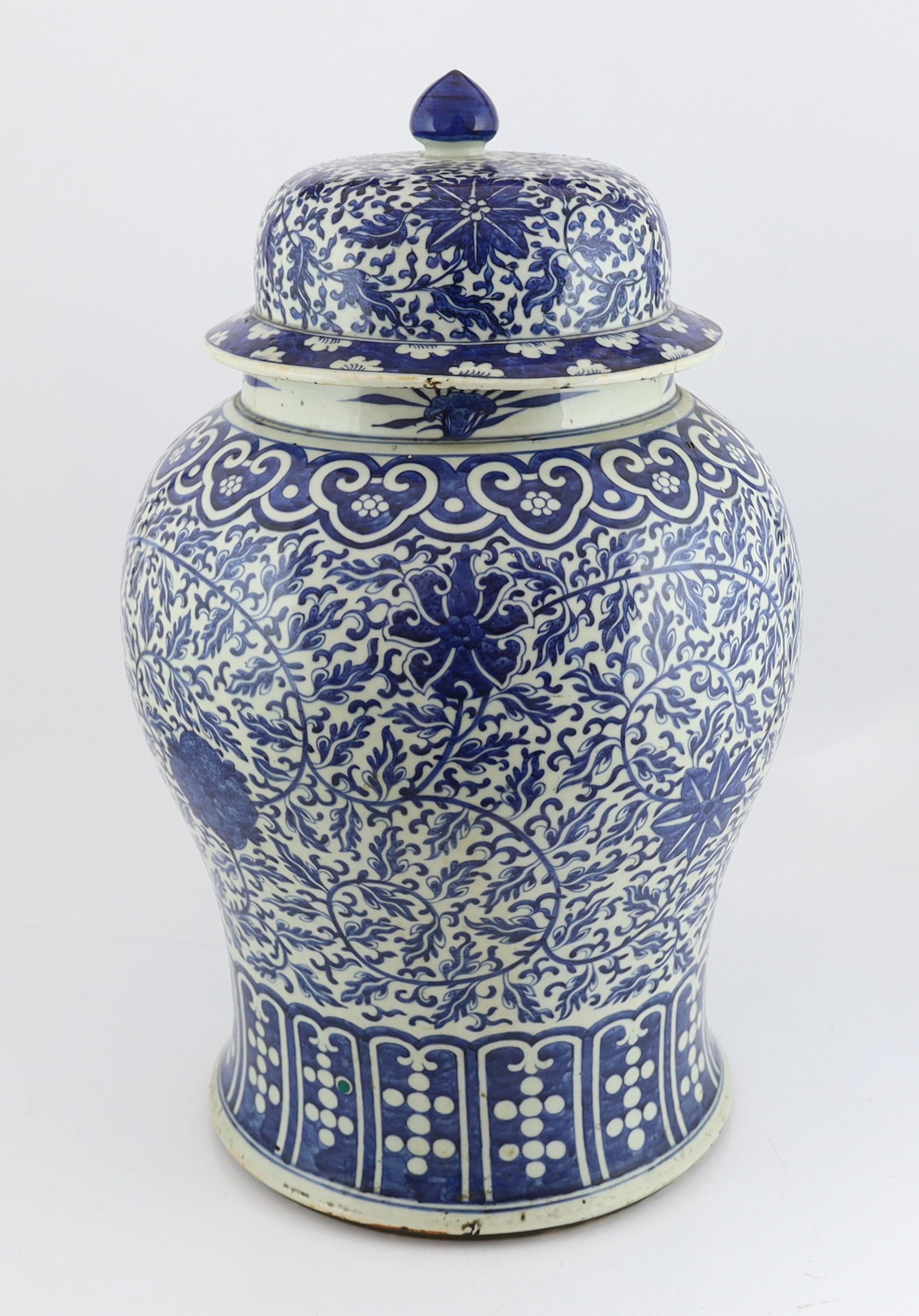 A massive Chinese blue and white ‘lotus’ vase and cover, 18th/19th century, broken and glued